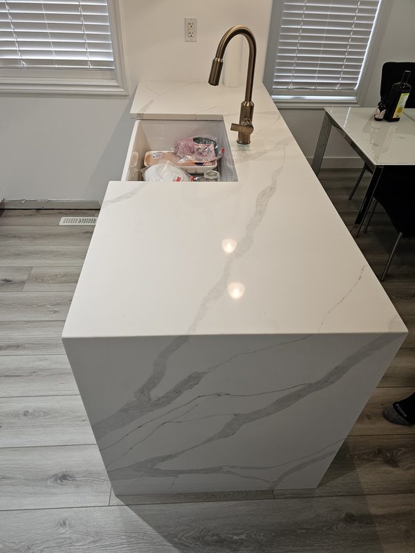 Waterfall quartz island with brushed brass faucet