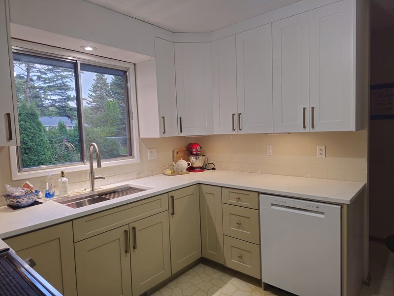 Sage green and white shaker kitchen cabinets